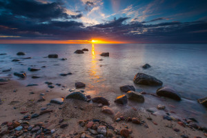 Beautifu rocky sea shore at sunrise or sunset. Long exposure landscape. Baltic sea near Gdynia in Poland.